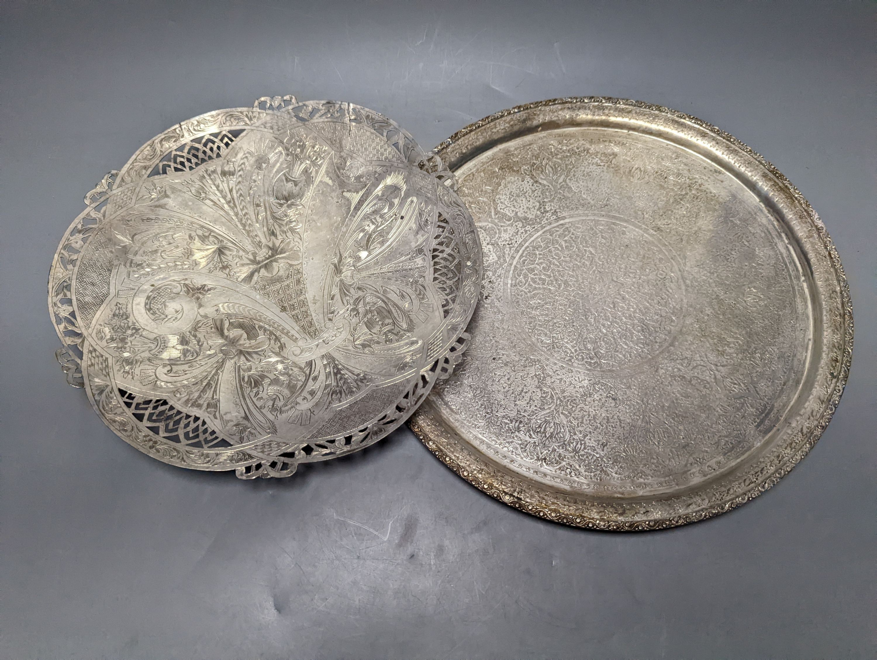 A Persian engraved white metal circular drink's tray by Vartan, 32cm, 747 grams and a white metal wall plaque.